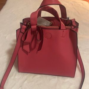 Deep pink soft leather handbag.